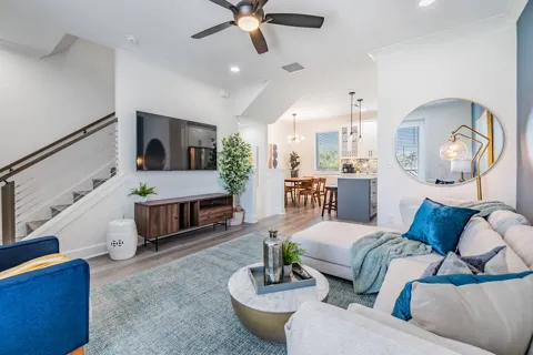 Living room with sofa, armchair and TV