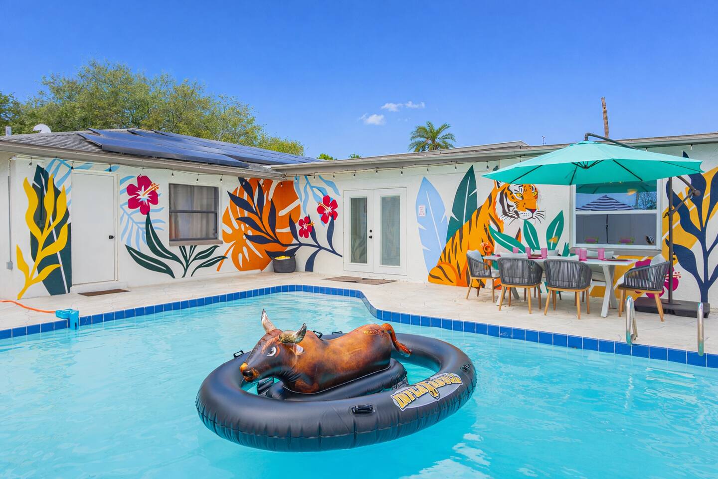 Attitude & Altitude private pool with colorful tropical murals and outdoor seating