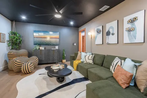 Living room with sectional and striped lounge chair