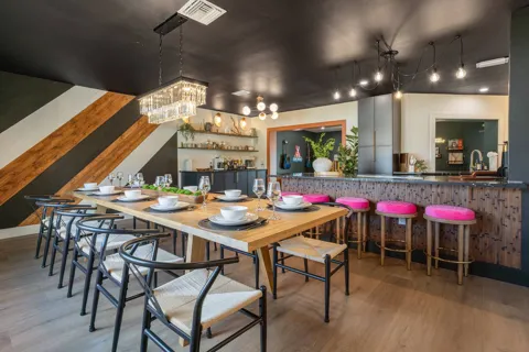 Dining area with wood table and chandelier